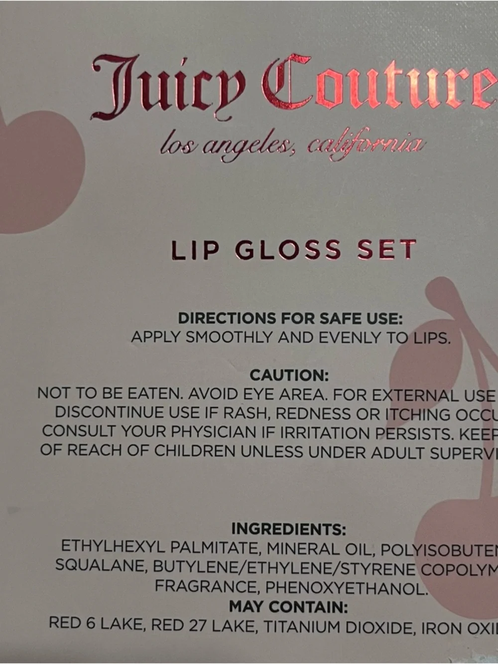 Juicy Couture lip gloss set that includes a beaded cherry keychain